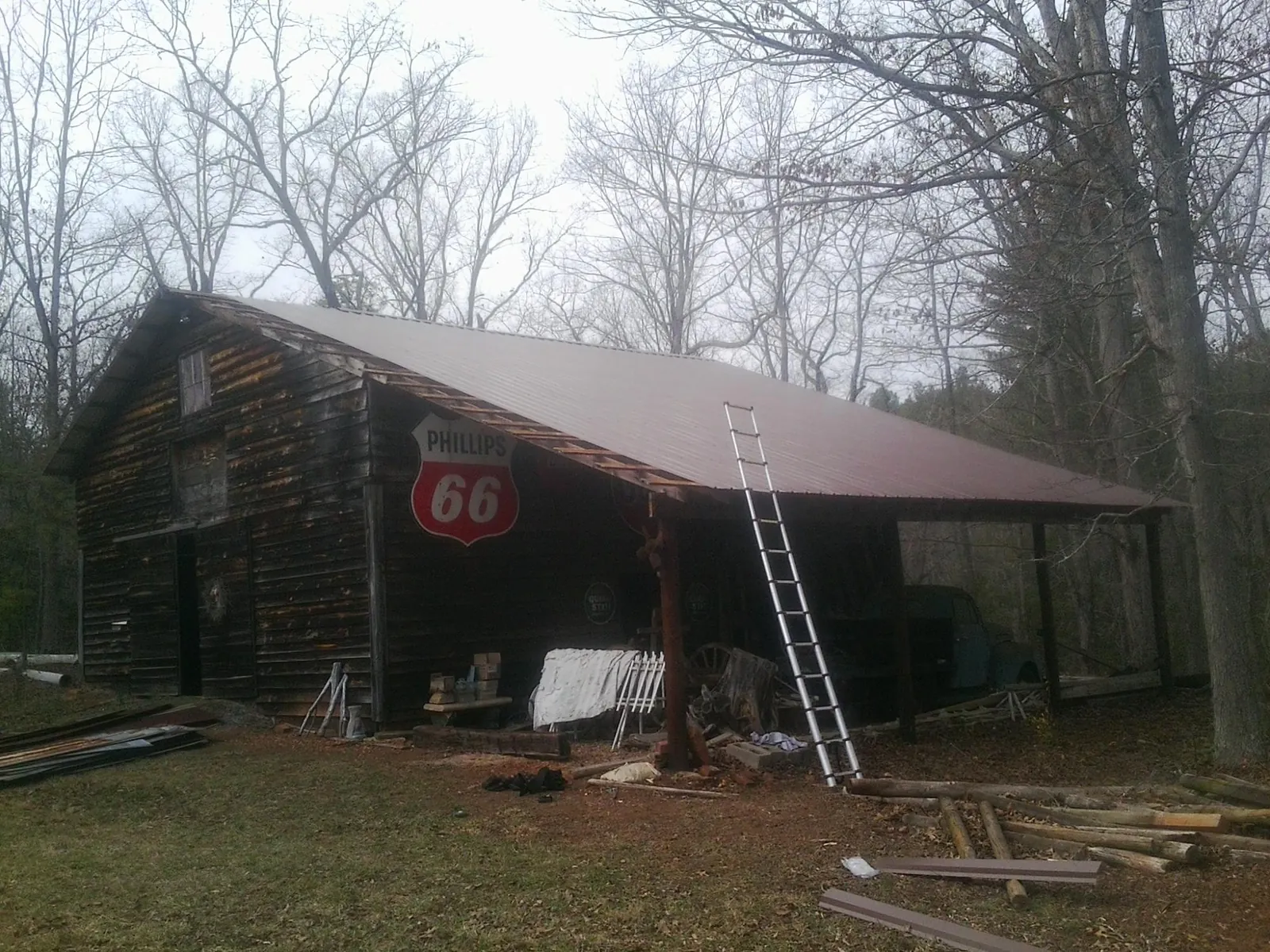 New metal roof on an open sided timber barn with a vintage sign in Fleischmanns