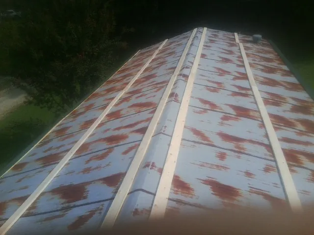 Rusted metal roof panels with new wood purlins before replacement — Storm Damage Roof Repair in Fleischmanns by Roofing Brothers